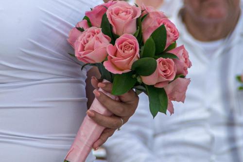 A bride holding a Bouquet of roses at her wedding ceremony