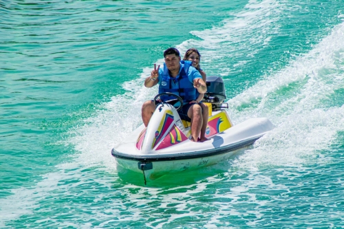 A couple of tourists driving a wave runner while in a tour in Cancun