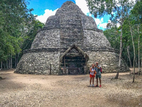 A couple of tourists taking a selfie at one of the Coba Archaeological Zone Pyramids
