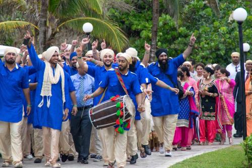 Indian men waving hands accompanying the groom in route to the Wedding Ceremony