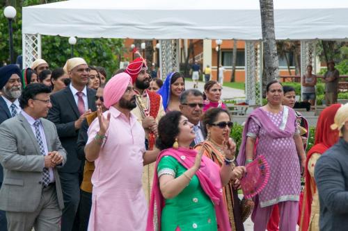 Indian men and girls waving hands in route to the Wedding Ceremony