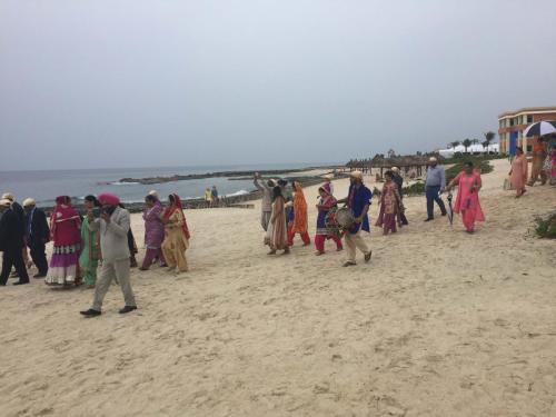 People assisting to an Indian Wedding at the Riviera Maya Beach