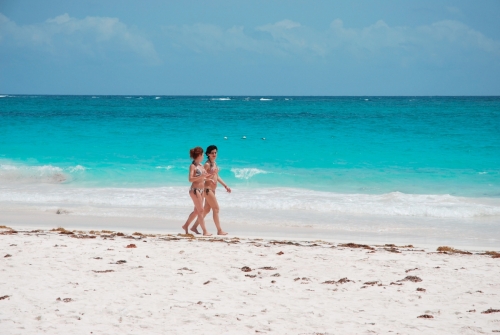 A couple of girls walking at the Tulum Beach